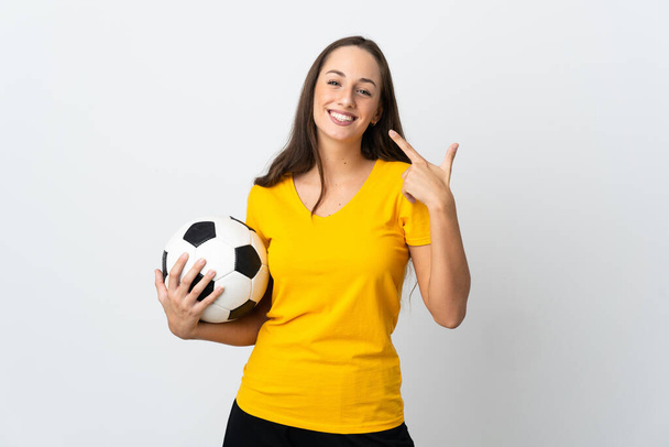 Young football player woman over isolated white background giving a thumbs up gesture - Photo, Image