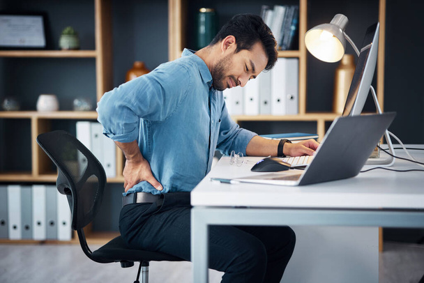Back pain, man and stress of desk worker, muscle injury and health risk on chair. Uncomfortable worker, spine problem and posture of body, scoliosis and fatigue of backache, burnout and fibromyalgia. - Fotografie, Obrázek