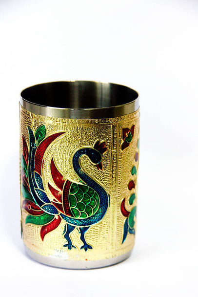View of brass, peacock-etched, empty pen stand against white background - Photo, Image
