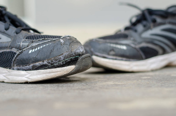 broken old black shoes on the floor. copy space - Zdjęcie, obraz