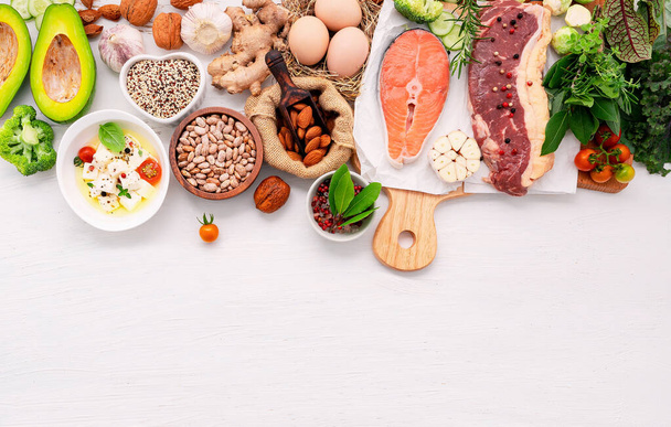 Ketogenic low carbs diet concept. Ingredients for healthy foods selection set up on white wooden background. - Photo, Image