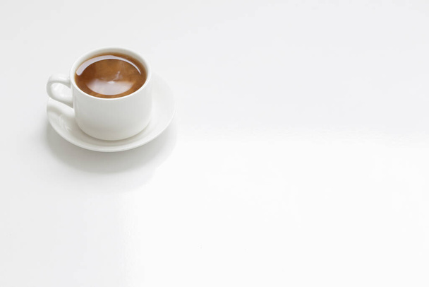 white cup of coffee  on white table - Fotó, kép