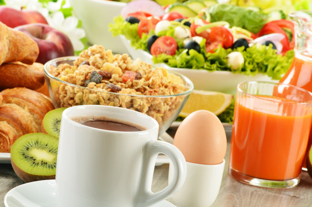 Breakfast with coffee, juice, croissant, salad, muesli and egg - Photo, Image