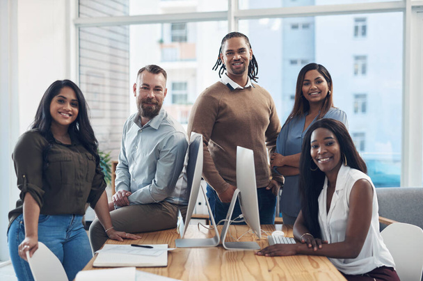 Were on our way to greatness. Cropped portrait of a diverse group of businesspeople surrounding a boardroom desk during a meeting in the office - Foto, immagini