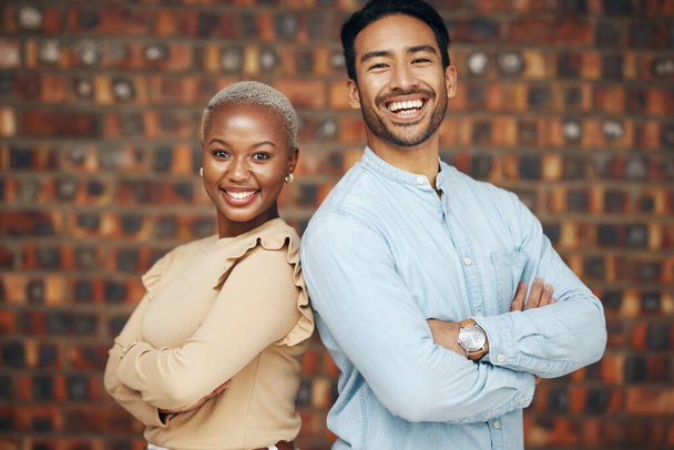 Young, professional team and partnership, portrait with teamwork and friends against wall background. Happy working together, creative pair and diversity, black woman and man, collaboration and trust. - 写真・画像