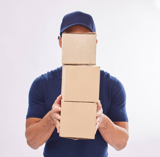 Delivery guy package, shipping boxes and export employee in studio with courier service. Box, supply chain and parcel logistics of a worker with distribution, online shopping and mail services. - Photo, Image