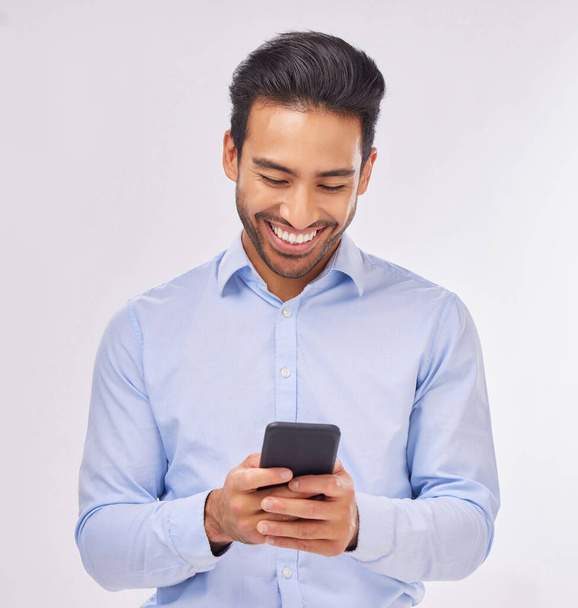 Smile, phone and business man typing in studio isolated on a white background. Cellphone, web networking and happy male professional with smartphone for reading, social media or mobile app online - Φωτογραφία, εικόνα