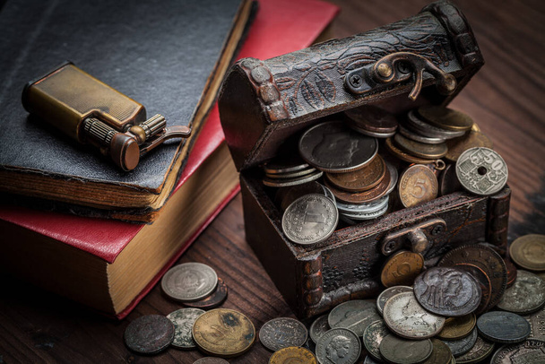 Старые монеты со всего мира с 1940 по новое тысячелетие и старинные предметы, такие как зажигалка и книги эпохи - Фото, изображение