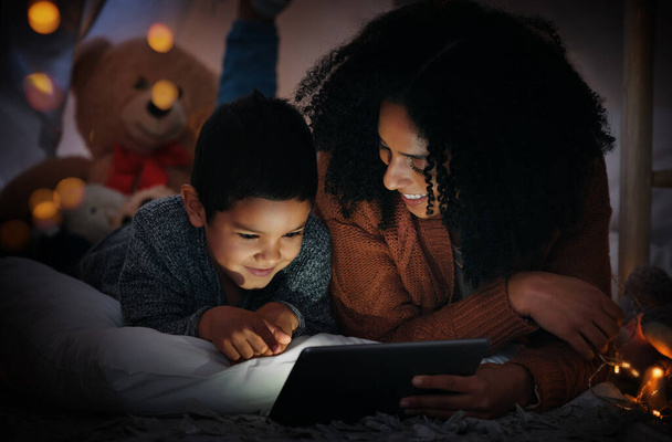 Movie, dark and a mother and child with a tablet before bedtime for a show, video or meme. Happy, streaming and a mom and boy kid watching a film, cartoon or series online with technology at night. - Photo, Image