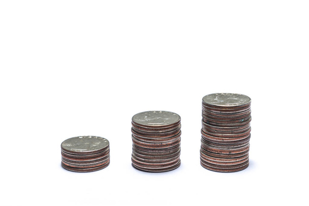 Three growing stacks of quarters with each pile of coins getting taller for a savings or financial investment growth strategy concept isolated on a  white background with copy space. - Фото, зображення