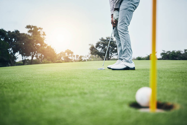 Ground, golf hole and man with golfing club on course for game, practice and training for competition. Professional golfer, sports and male athlete hit ball on grass for winning, score or tee stroke. - Zdjęcie, obraz