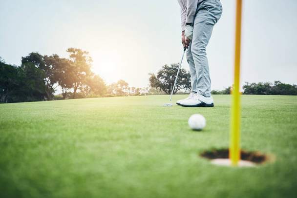 Sports, golf hole and man with golfing club on course ground for game, practice and training for competition. Professional golfer, grass and male athlete hit ball for winning, score or tee stroke. - Photo, Image