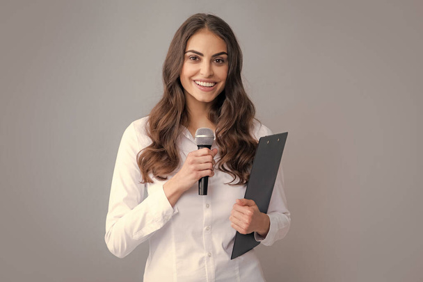 Young business woman talking with mic. Woman talking with microphone. Communication and information concept - Foto, Imagen
