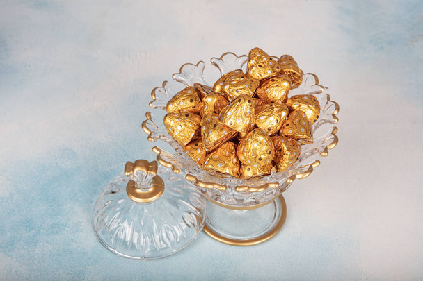 Chocolate sweets in golden foil, Stock image