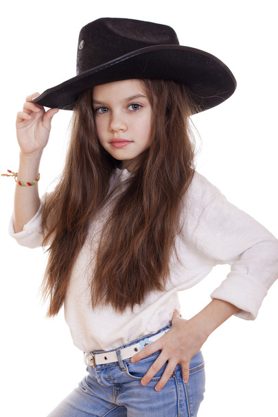 Portrait of a beautiful little girl in a black cowboy hat - Fotografie, Obrázek