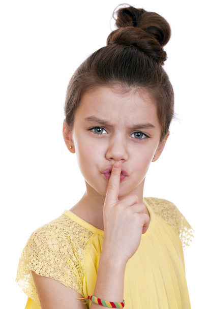 Little girl has put forefinger to lips as sign of silence - Фото, изображение