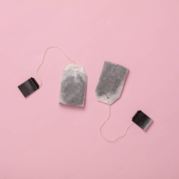 Two tea bags on a pink background. Top view - Fotoğraf, Görsel