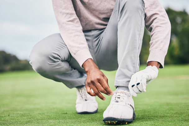 Sports, laces and shoes of man on golf course for training, games and tournament match. Ready, start and tying with male athlete playing in club on lawn field for relax, golfing and competition. - Photo, Image