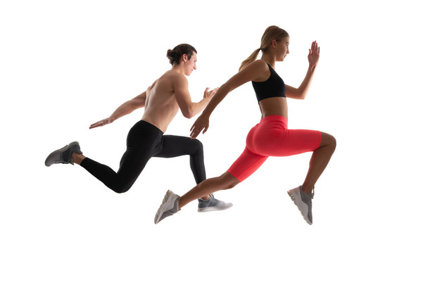sport couple running isolated on white. sport couple running in studio. sport couple running on background. photo of sport couple running wearing sportswear. - Foto, immagini
