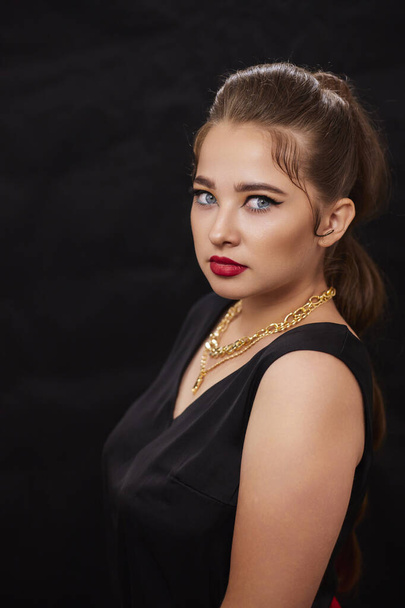 portrait shot of a young Ukrainian woman on the background, after make-up and hairstyle, for clothing advertising. - Foto, afbeelding
