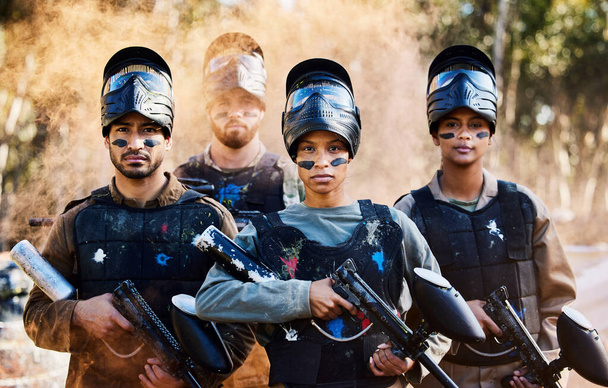 Team, paintball and portrait of army ready for battle, war or intense combat in extreme adrenaline sports. Group of people standing with guns in teamwork preparation for mission or sport match. - Photo, Image