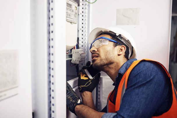 Man, phone call and engineering in control room, switchboard or industrial system inspection. Male electrician talking on smartphone at power box, server mechanic or electrical substation maintenance. - Foto, Bild
