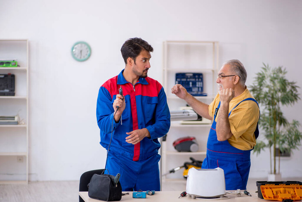 Two repairmen working at workshop - Photo, Image