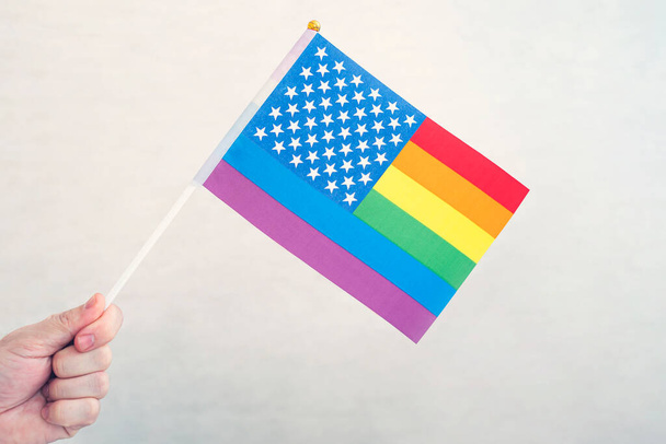 USA flag and flag of LGBT community. problem of rights of sexual minorities in country. Protection and infringement rights. non-traditional relations and politics concept. legalizing same-sex marriage - Photo, Image