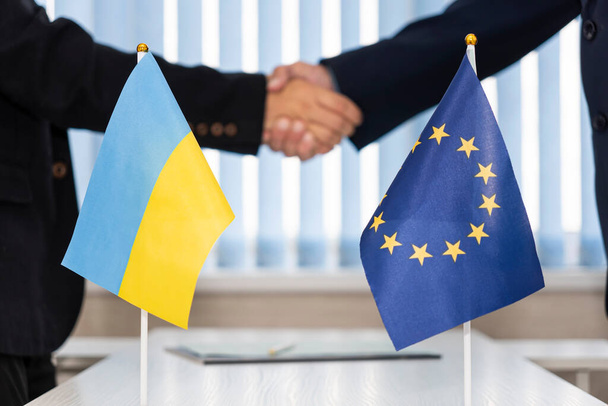 Political flags of Ukraine and European Union.. concept of negotiations, collaboration and cooperation of countries. agreement between the governments. Ukraine's accession to the European Union. - Photo, Image