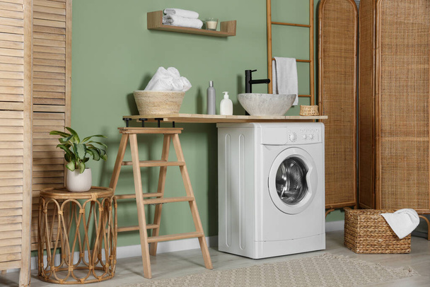 Stylish laundry room with functional washing machine. Interior design - Fotó, kép