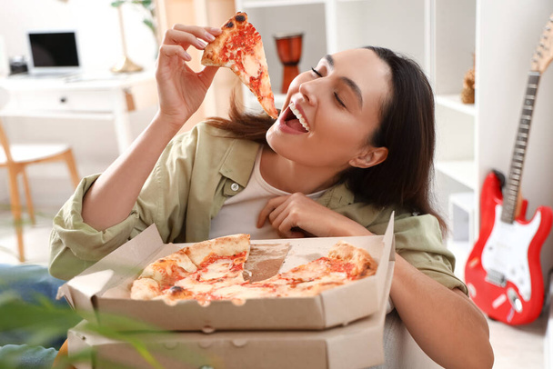 Beautiful woman with box of tasty pizza at home, closeup - Photo, Image