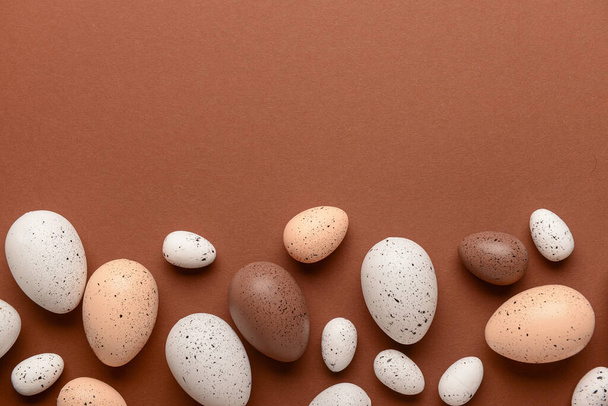Composition with Easter eggs on brown background - Foto, imagen