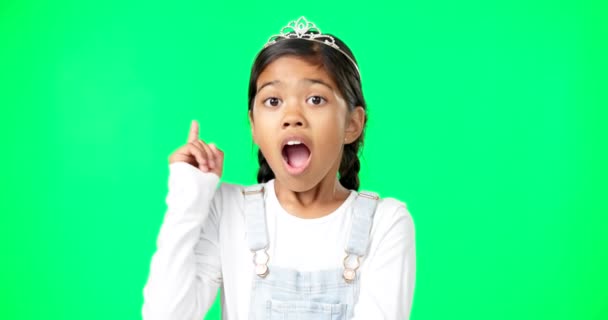 Green screen, idea and portrait of surprised child feeling excited, happy and isolated in a studio background. Smart, clever and young girl or kid pointing up at brand, product placement or mockup. - Video, Çekim