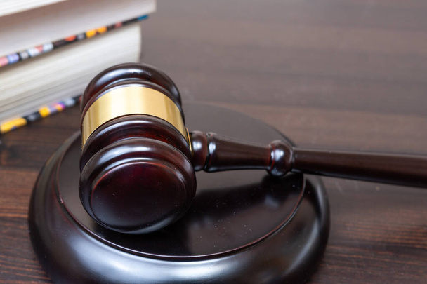 Judge's gavel on wooden table, background of legal books. Concept of legal legislation - Φωτογραφία, εικόνα