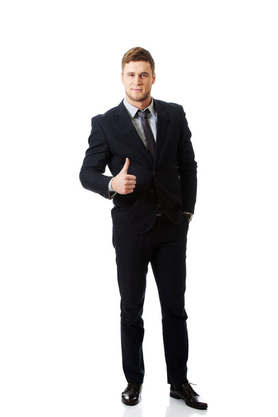 Businessman with thumb up. - 写真・画像