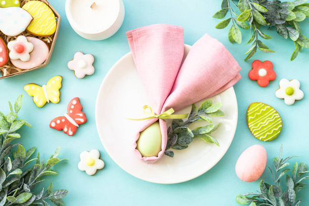 Easter food background. White plate with eggs, spring flowers and easter cookies. Flat lay. - Photo, Image