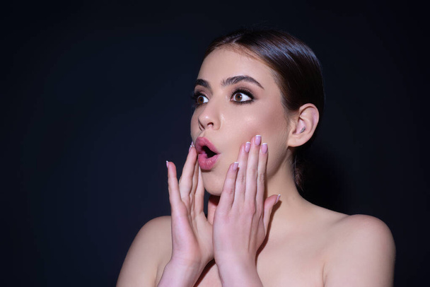 Close up photo of impressed woman isolated over studio background. Portrait of an excited young girl looking in excitement. Young woman shocked with surprise expression, amazed and excited face - Фото, изображение