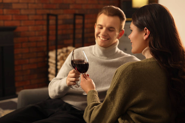 Happy lovely couple with glasses of wine resting together at home - Фото, зображення