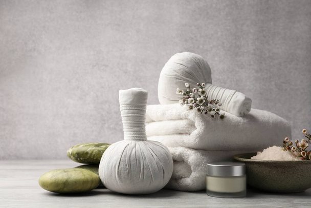 Composition with spa products and flowers on grey wooden table. Space for text - Фото, зображення