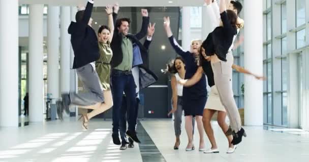 Yay. Fun, excited and jumping group of business people smiling and having fun in a modern building. A team of happy and cheering men and women at the end of a long and successful day - Metraje, vídeo
