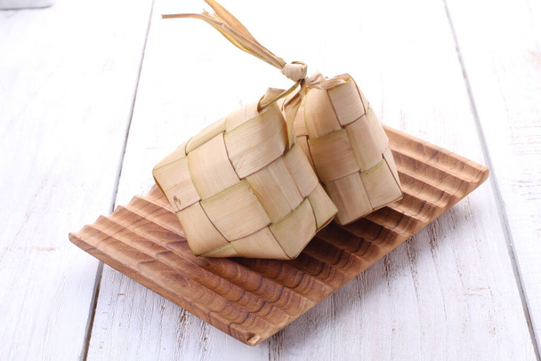 A ketupat (indonéz és maláj nyelven), kupat (jávai és Sundanese nyelven) vagy tipat (balinéz nyelven) az Indonéziából származó, gyémánt alakú, pálmafalevél-tasakos tartályba csomagolt rizsből készült gombóc.. - Fotó, kép