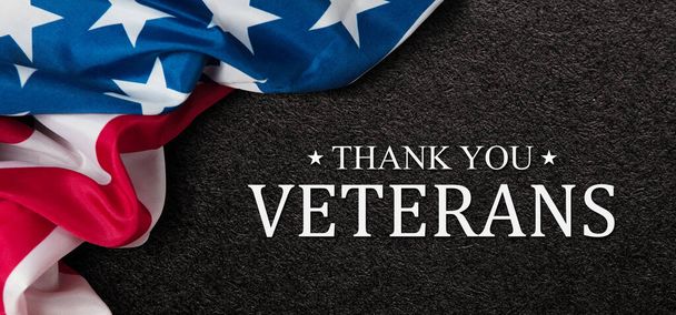 Closeup of American flag with Text Thank You Veterans on black textured background. American holiday banner. - Fotoğraf, Görsel