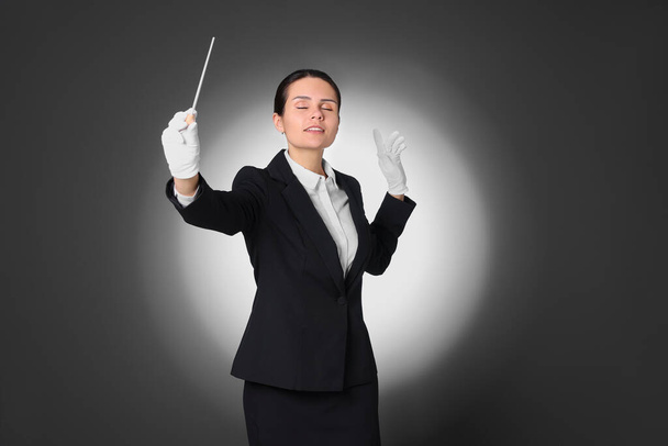 Professional conductor with baton on grey background - Foto, Imagem