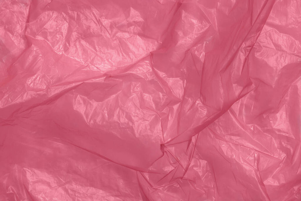 Crumpled red plastic bag as background, top view - Foto, immagini