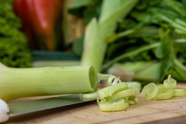 Vegetables cut on wooden board. Edible food. Ingredients for salads. Vegan cuisine. Healthy eating. - Zdjęcie, obraz