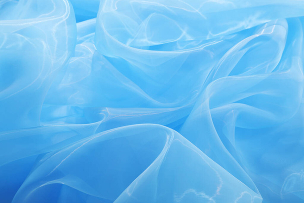 Beautiful light blue tulle fabric as background, closeup - Foto, afbeelding