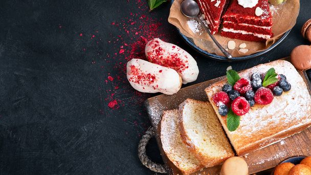 Different desserts on dark background. Delicious sweet dessert table with pound cake, chocolate and red velvet cakes. Holiday  sweet eating concept. Top view, copy space - Photo, Image