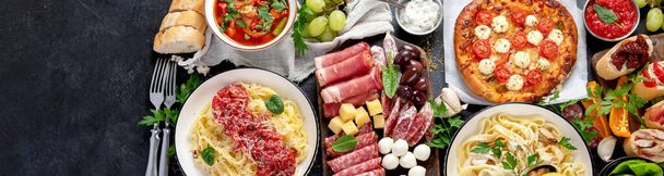 Italian food dishes on dark background. Traditional italian cuisine  concept. Dishes and appetizers of indeed cuisine. Mideterranean diet high in vitamin and antioxidants. Top view, copy space,panorama, banner - Fotó, kép
