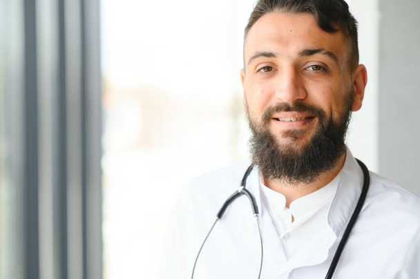 Portrait of a young Arab doctor in the clinic. Healthcare concept. - Foto, Imagen