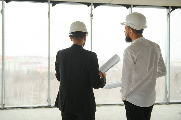 Multiethnic business team. Construction concept. Indian and Arab engineers inspect the construction - Φωτογραφία, εικόνα